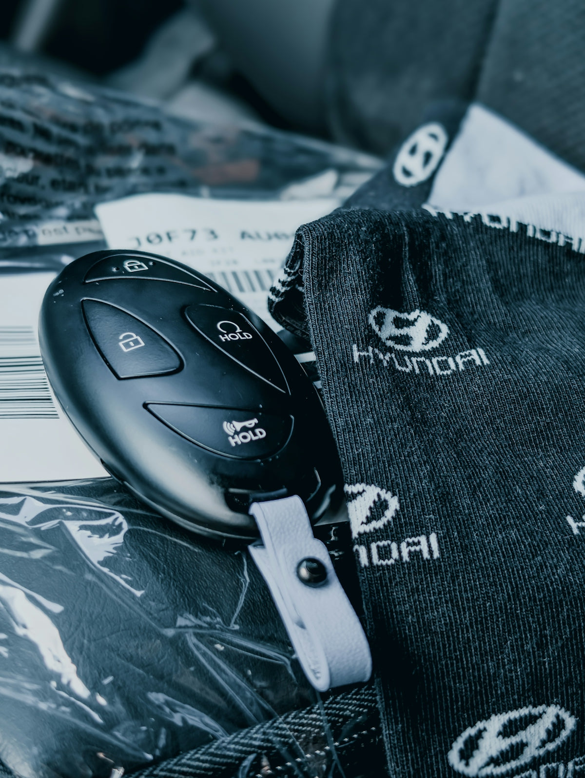 A hyundai car key rests near branded accessories