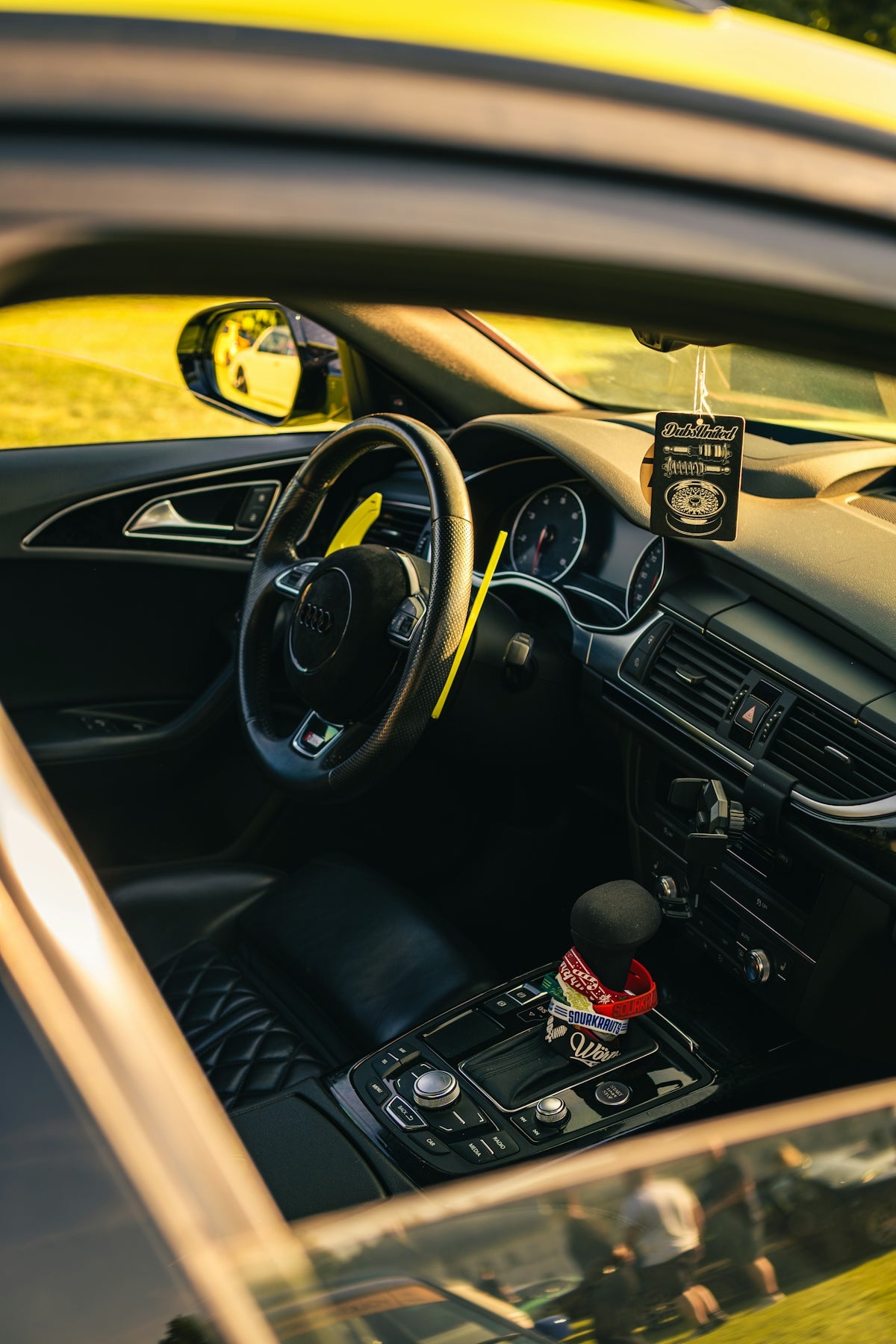 Interior view of a luxury car's dashboard and steering wheel